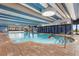 Large indoor swimming pool with blue and white striped ceiling and ample natural light at 1105 S Ocean Blvd. # 110, Myrtle Beach, SC 29577