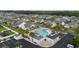 Aerial view of the community pool, showing the clubhouse, parking lot, and surrounding homes at 1224 Checkerberry St., Longs, SC 29568