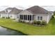 The backyard features a screened in porch and a view of the pond at 1224 Checkerberry St., Longs, SC 29568