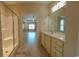 Bathroom with bright lighting, tiled shower, and ample storage in the vanity at 1224 Checkerberry St., Longs, SC 29568