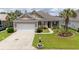 Charming single-story home featuring a well-manicured lawn, two-car garage, and inviting landscaping at 1224 Checkerberry St., Longs, SC 29568