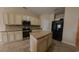 Open kitchen featuring granite countertops, a kitchen island, stainless appliances, and tile flooring at 1224 Checkerberry St., Longs, SC 29568