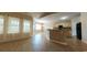 Bright, open-concept kitchen with a large island, neutral-toned cabinets, black appliances, and tiled floors at 1224 Checkerberry St., Longs, SC 29568
