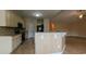 Kitchen with black appliances and a kitchen island overlooking an adjacent room at 1224 Checkerberry St., Longs, SC 29568