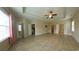 Open floor plan main bedroom with bright lighting, tile floors, and ample space at 1224 Checkerberry St., Longs, SC 29568