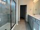 Bathroom with a glass shower, double vanity, and neutral-toned tile at 1232 Lady Bird Way, North Myrtle Beach, SC 29582