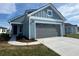 Charming home featuring hardiplank siding, a grey garage door, and a well-manicured lawn at 1232 Lady Bird Way, North Myrtle Beach, SC 29582
