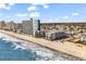 Panoramic aerial view of the beach with condominiums and oceanfront access on a clear day at 1310 N Waccamaw Dr. # 208, Garden City Beach, SC 29576