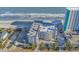 Aerial view of condo buildings along the beach, featuring oceanfront access and on-site parking at 1310 N Waccamaw Dr. # 208, Garden City Beach, SC 29576