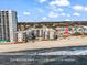 Aerial view of beach side condo with overflow parking lot at 1310 N Waccamaw Dr. # 208, Garden City Beach, SC 29576