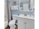 Bathroom with shower and tub combo, white cabinets, and a mirror at 1310 N Waccamaw Dr. # 208, Garden City Beach, SC 29576