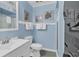 Bright bathroom with shower-tub, toilet, and single sink vanity with ocean themed decorations at 1310 N Waccamaw Dr. # 208, Garden City Beach, SC 29576