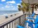 Charming balcony with blue Adirondack chairs offering amazing beach and ocean views at 1310 N Waccamaw Dr. # 208, Garden City Beach, SC 29576