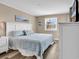 Bedroom featuring an ocean view, white dresser and neutral wall at 1310 N Waccamaw Dr. # 208, Garden City Beach, SC 29576