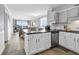 Modern kitchen open to the living space with white cabinetry and stainless appliances at 1310 N Waccamaw Dr. # 208, Garden City Beach, SC 29576