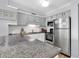 Well-equipped kitchen with modern stainless steel appliances and ample counter space at 1310 N Waccamaw Dr. # 208, Garden City Beach, SC 29576