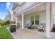 Back patio with a grill, seating, and a view of the home's exterior at 146 Georges Bay Rd., Surfside Beach, SC 29575