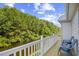 Balcony with chairs overlooking a serene waterway surrounded by lush greenery and trees at 146 Georges Bay Rd., Surfside Beach, SC 29575