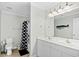 Functional bathroom with a double vanity, a shower with a whale themed curtain, and tile flooring at 146 Georges Bay Rd., Surfside Beach, SC 29575