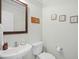 Half bathroom with modern sink, toilet, decorative mirror, and nautical themed decor at 146 Georges Bay Rd., Surfside Beach, SC 29575