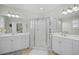 Bright bathroom with a double sink vanity, a glass shower, and neutral-colored tile flooring at 146 Georges Bay Rd., Surfside Beach, SC 29575