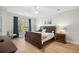 Comfortable bedroom with wood flooring, a sleigh bed, and natural light from a large window at 146 Georges Bay Rd., Surfside Beach, SC 29575
