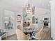 Inviting dining area adjacent to kitchen featuring a glass table, woven chairs, and chandelier lighting at 146 Georges Bay Rd., Surfside Beach, SC 29575