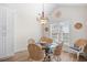 Cozy dining area with woven chairs, a glass-top table, and a chandelier for a welcoming atmosphere at 146 Georges Bay Rd., Surfside Beach, SC 29575