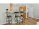 Kitchen bar with seating, wood cabinets, and an open layout to the adjacent rooms at 146 Georges Bay Rd., Surfside Beach, SC 29575