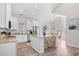 Well-lit kitchen featuring an island with seating, white cabinets, stainless steel appliances, and an adjacent dining area at 146 Georges Bay Rd., Surfside Beach, SC 29575