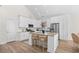 Bright kitchen with white cabinets, stainless steel appliances, granite countertops, and an island with seating at 146 Georges Bay Rd., Surfside Beach, SC 29575