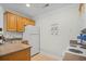 Kitchen featuring wood cabinets, a white refrigerator, and essential appliances at 146 Georges Bay Rd., Surfside Beach, SC 29575