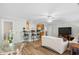 Cozy living room with wood flooring, a ceiling fan, kitchen bar, and comfortable seating at 146 Georges Bay Rd., Surfside Beach, SC 29575