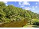 Scenic view of a peaceful waterway surrounded by lush, dense trees and greenery at 146 Georges Bay Rd., Surfside Beach, SC 29575