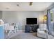 Bright dining area featuring a tv and a comfortable chair near sliding doors to a screened patio at 1460 Blue Tree Ct. # E, Myrtle Beach, SC 29588