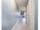 Bright hallway with wood-look flooring leading to living area with white table and chairs at 1460 Blue Tree Ct. # E, Myrtle Beach, SC 29588