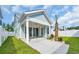 Inviting covered patio with ceiling fan and sliding glass doors leading to a lush, private backyard oasis at 1545 Coastal Cove Ln, Calabash, NC 28467