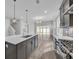 Bright kitchen with stainless steel appliances, island sink, and open floor plan at 1545 Coastal Cove Ln, Calabash, NC 28467