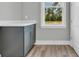 Functional laundry room with neutral cabinets, a white countertop, and a bright window at 1545 Coastal Cove Ln, Calabash, NC 28467