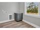 Neutral laundry room with gray cabinets, countertop space, and natural light from a window at 1545 Coastal Cove Ln, Calabash, NC 28467