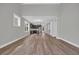 Open floor plan with modern kitchen, wood-look floors, and abundant natural light at 1545 Coastal Cove Ln, Calabash, NC 28467