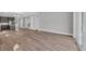 Open floor plan showcasing wood-look floors, stairs, and view of modern kitchen at 1545 Coastal Cove Ln, Calabash, NC 28467