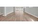 Spacious living room featuring wood-look floors and sliding glass doors at 1545 Coastal Cove Ln, Calabash, NC 28467