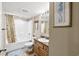 Cozy bathroom features a tub and shower combination with a charming vanity at 1625 S Ocean Blvd. # 309, North Myrtle Beach, SC 29582