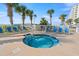 Inviting hot tub surrounded by lounge chairs and lush palm trees at 1625 S Ocean Blvd. # 309, North Myrtle Beach, SC 29582