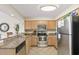 Cozy kitchen featuring granite countertops, stainless steel appliances and tile flooring at 1625 S Ocean Blvd. # 309, North Myrtle Beach, SC 29582