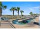 Outdoor pool area with palm trees, chairs, and ocean views at 1625 S Ocean Blvd. # 309, North Myrtle Beach, SC 29582