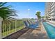 Relaxing pool deck with lounge chairs and palm trees overlooking the ocean at 1625 S Ocean Blvd. # 309, North Myrtle Beach, SC 29582