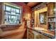 Rustic bathroom featuring wood paneled walls, wood countertop and trim, and a decorative window with a view at 181 Halfway Rd., Nichols, SC 29581