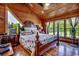 Cozy wood paneled primary bedroom with a large windows offering serene views of the outdoors at 181 Halfway Rd., Nichols, SC 29581